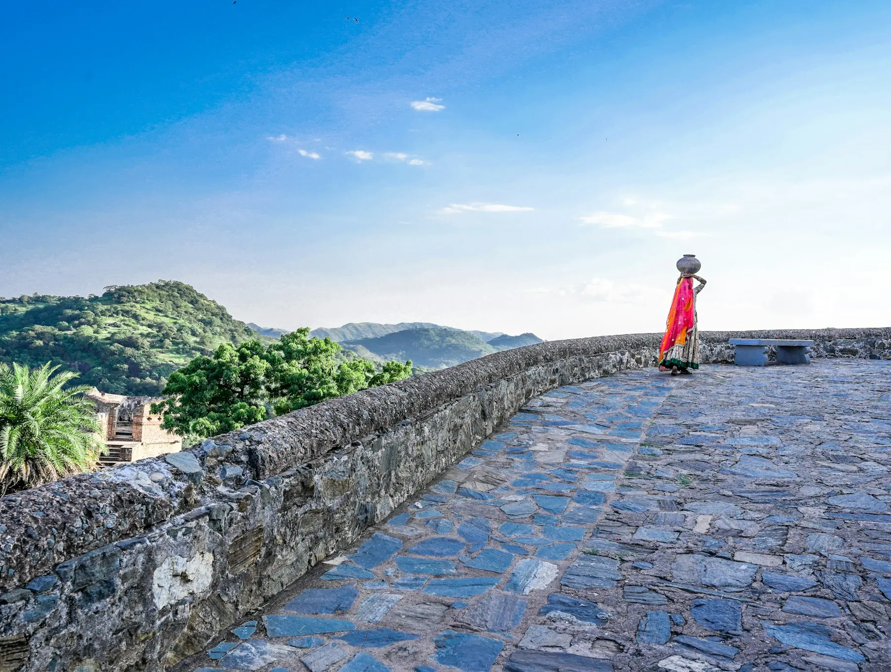 A woman crossing a palace courtyard in Rajasthan